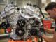 An employee works on a sports car engine at Lotus’s Hethel plant in Norfolk