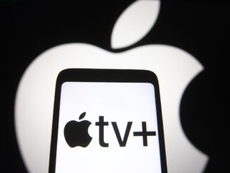 In this photo illustration an Apple TV+ logo is seen on a smartphone screen with an Apple logo in the background.