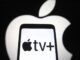 In this photo illustration an Apple TV+ logo is seen on a smartphone screen with an Apple logo in the background.