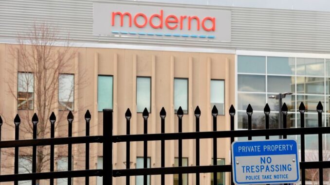 Image of a building with the Moderna logo behind a security fence.