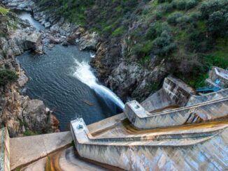 a photo of a dam in Spain seen spilling water.