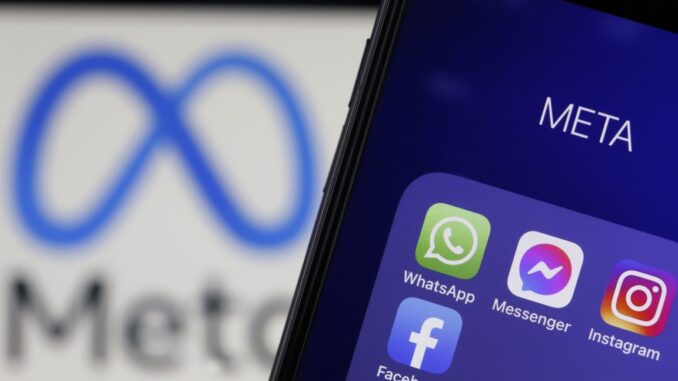 In this photo illustration, the icons of WhatsApp, Messenger, Instagram and Facebook are displayed on an iPhone in front of a Meta logo