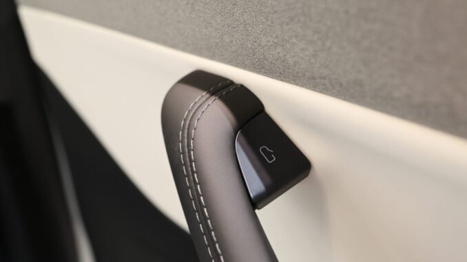 The interior door handle of a Tesla Model 3 electric vehicle at a pop-up Tesla Inc. store on its opening day in Riga, Latvia, on Friday, Aug. 21, 2026. Tesla Inc. and at least eight other carmakers are recalling millions of cars in China over safety concerns with their door handles. Photographer: Andrey Rudakov/Bloomberg via Getty Images