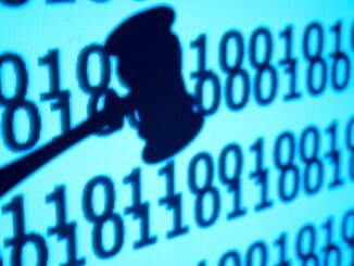 An image of a close up gavel in front of code, concept of justice and lawsuit