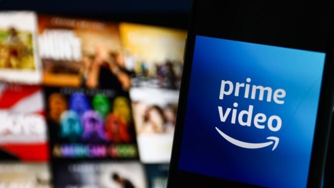 The logo of Amazon Prime Video against a blurred backdrop of tiles on a television screen.