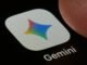 A macro close-up photograph shows the Google Gemini AI app icon