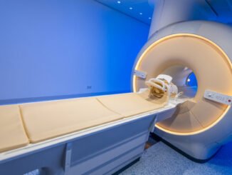 Image of an MRI tube in a room with blue lighting.