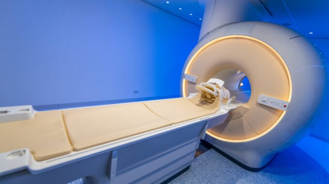 Image of an MRI tube in a room with blue lighting.